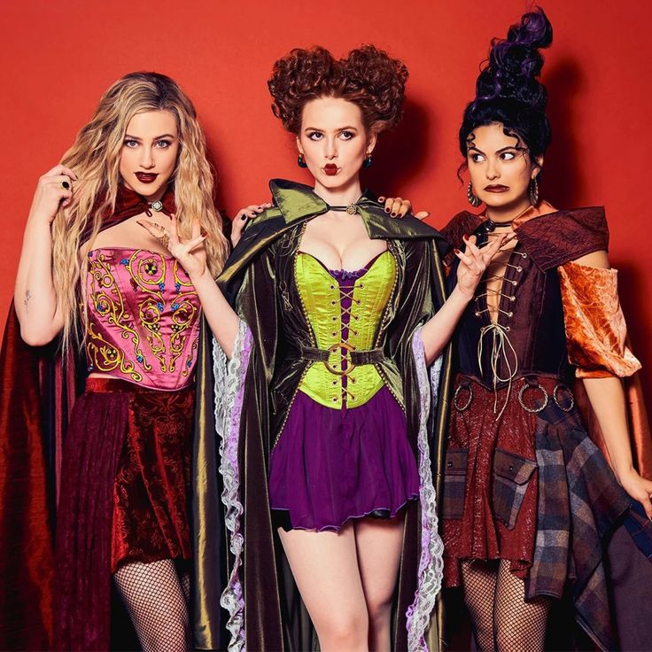 Group Halloween costumes featuring three witch friends in colorful spooky outfits.